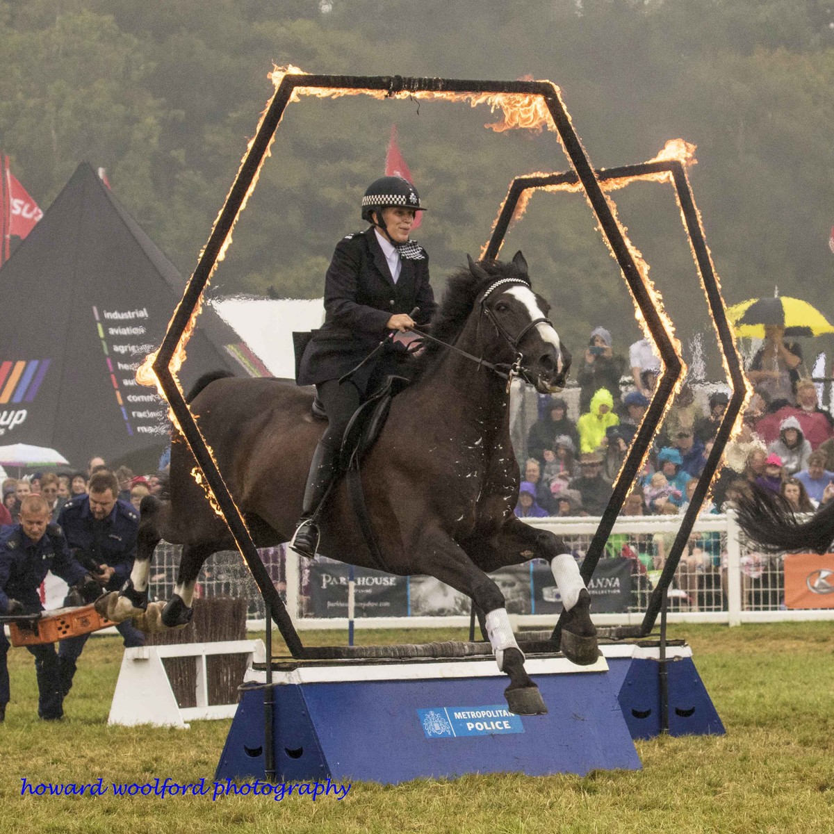 Metropolitan mounted police display, New Forest Show, horse jumping through a ring of fire